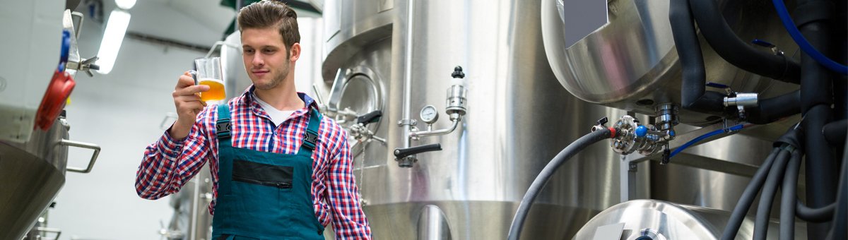 Man looking at beer in glass