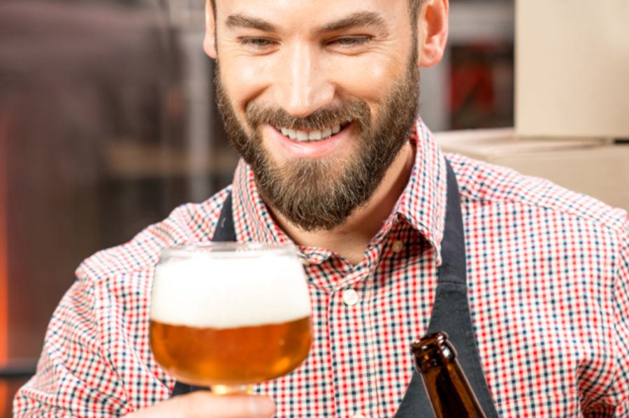 Man with glass of beer and bottle